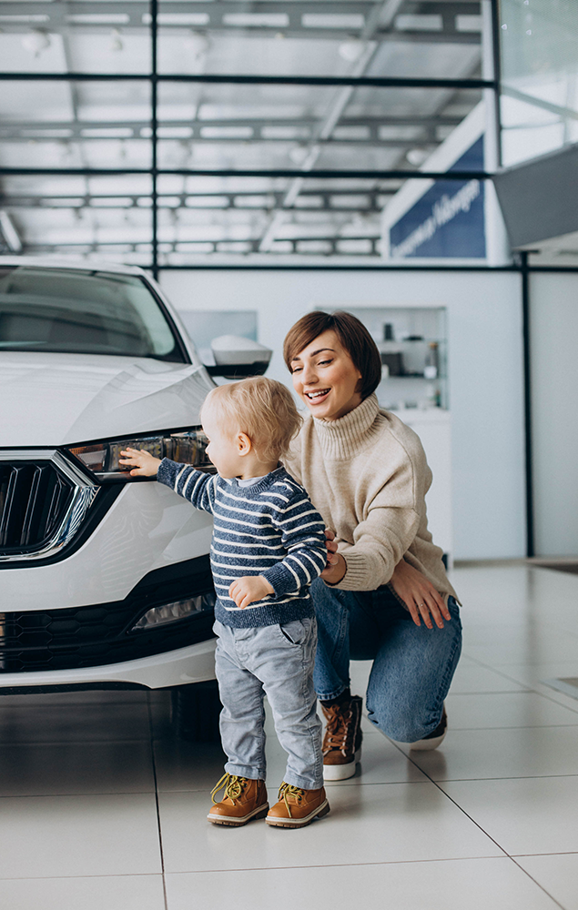 woman with baby son choosing car car salon